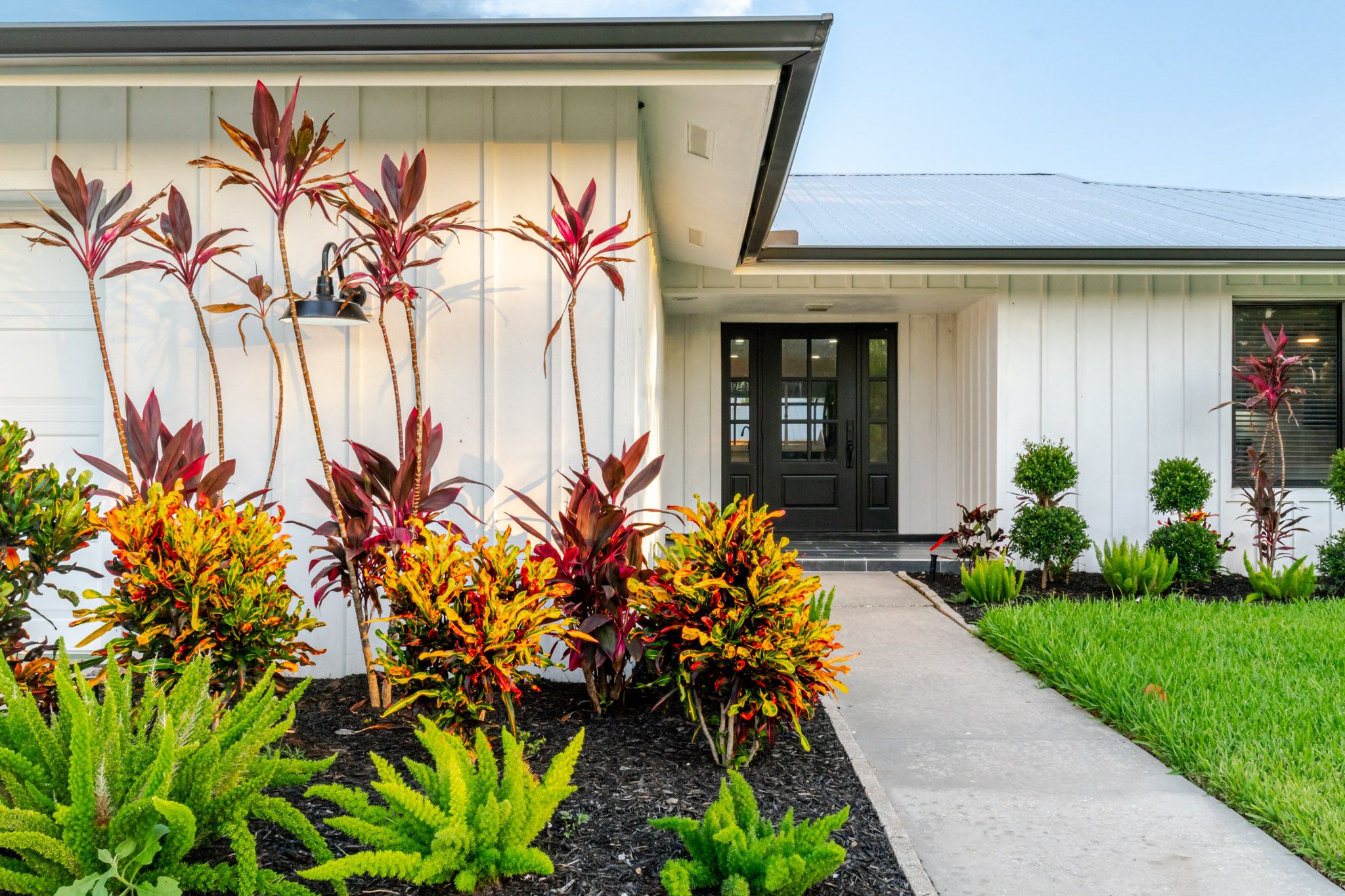 Side exterior with tropical garden.