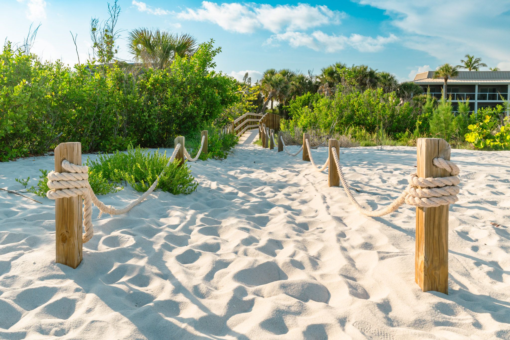 Sandy path leading toward the beach on Sanibel Island.